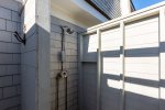 Rinse off the beach sand in the outdoor shower 